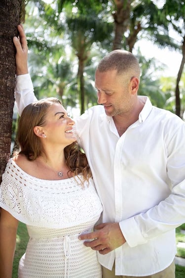 Couple smiling beneath palms at Premier Residences Phu Quoc