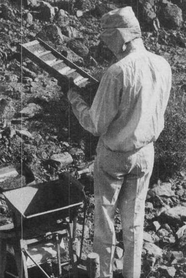 a man in a mining outfit holding mining equipment