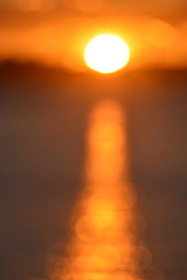 painterly photo ofa sunset over the water