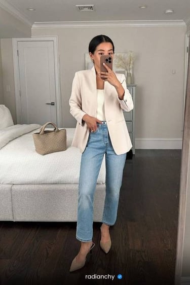 a woman in jeans and a white blazer jacket