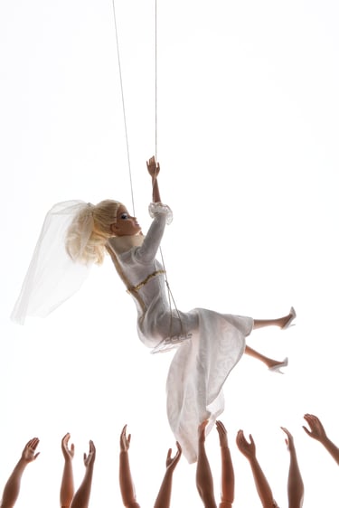 a woman in a white dress is suspended from a string