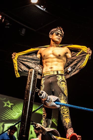 Jake De Leon standing on a turnbuckle in a wrestling ring