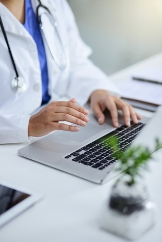 A doctor in front of her laptop