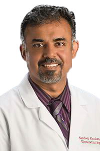 man wearing a white lab coat with a shirt and tie on