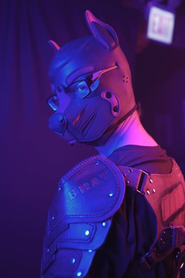 A man in a pup mask and leather gear.