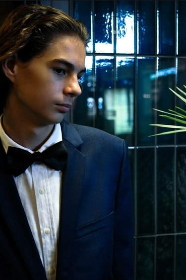 a man in a tuxedo suit and bow tie