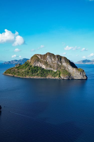 a small island with a small island in the middle of the ocean