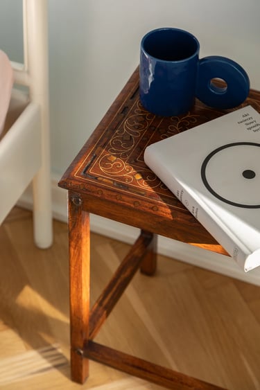 Makrofotografia: detal intarsji na stoliku vintage i gra światła.