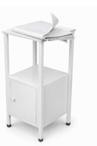 Minimalist white metal side table with a storage cabinet and a newspaper on top.