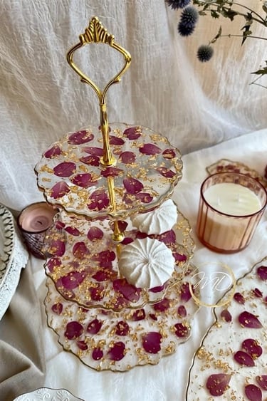 tiered dessert stand with a cake, made from epoxy resin, rose petals decor