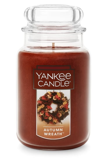 Large amber candle jar labeled Autumn Wreath, fall-inspired scent.