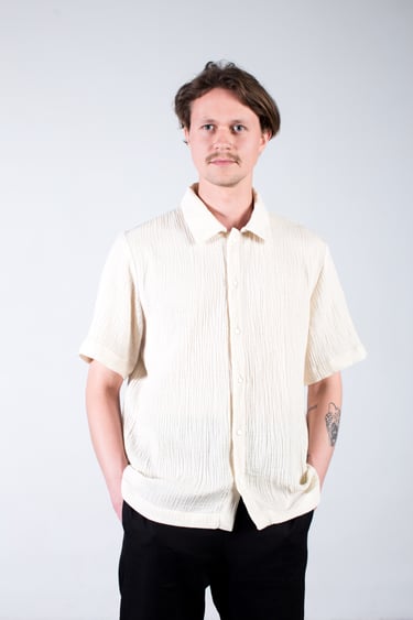 a man with muslin shirts