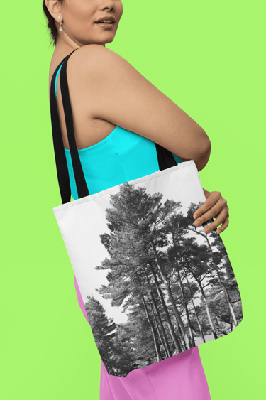 a woman in coloured clothing holding a tote bag