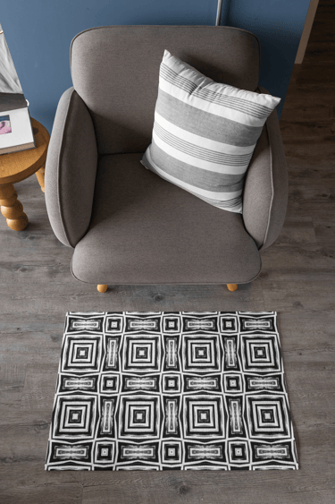 Area rug on floor in front of chair.