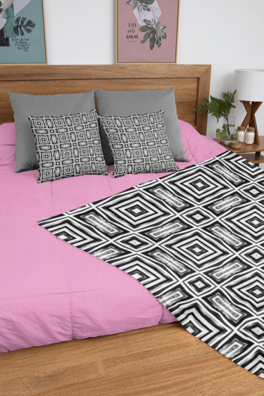 Throw Blanket with Throw Pillows on a bed.