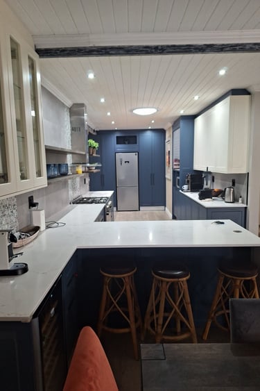 a kitchen with a counter top and stools