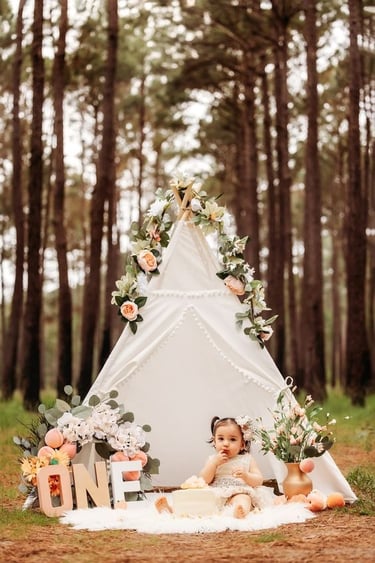 a baby girl in a teepeeh tent with a teepeeh tent