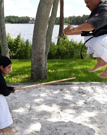 Kobudo practice with traditional Okinawan weapons in martial arts dojo