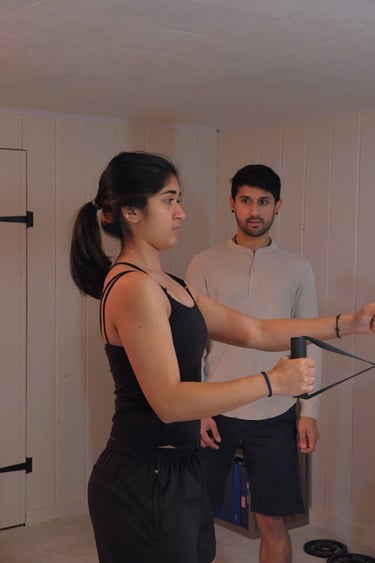 woman performing exercise, supervised by a trainer, to improve posture