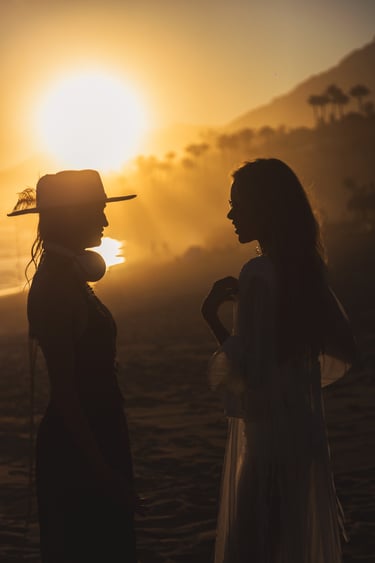 Sophisticated members of the SOLÉ tribe enjoying the golden hour at a luxury Marbella beach club.