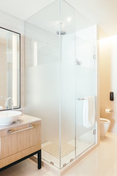 Contemporary bathroom with frosted glass shower and wooden vanity – finished look after a cracked tr