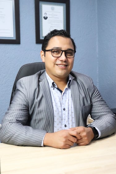 Dr. Daniel Rodriguez, smiling, attends to a patient