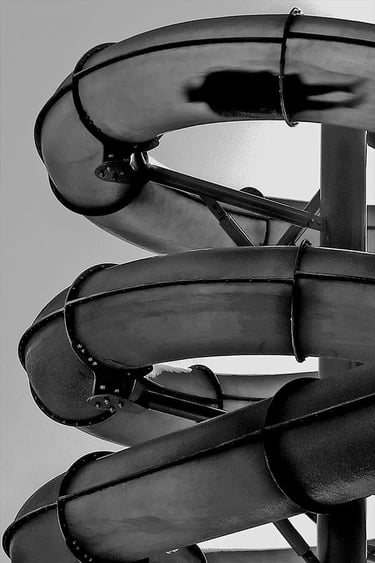 Black and white image of a person on a waterslide at Glenelg.