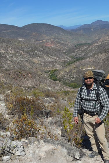 a man with a backpack on a mountain