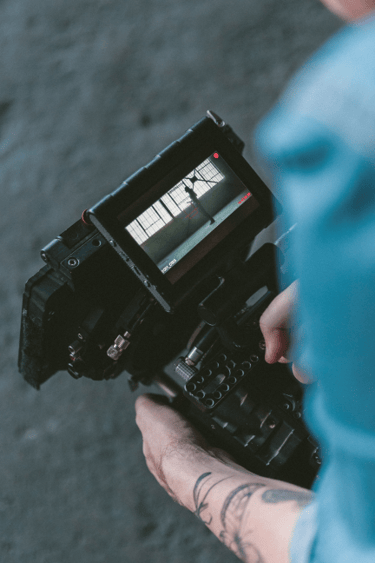 a person holding a camera and a cell phone