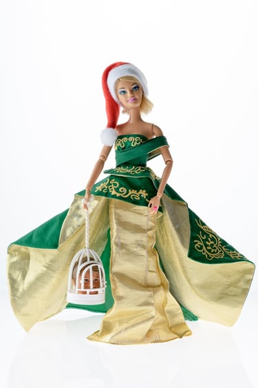 a doll wearing a green dress and santa claus hat