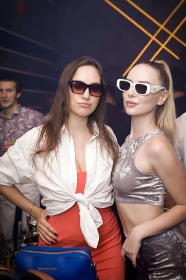 two women in sunglasses and sunglasses standing next to each other