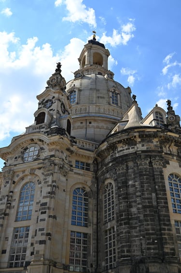 Dresden Frauenkirche Baroque architecture featuring its iconic stone dome against a blue sky.