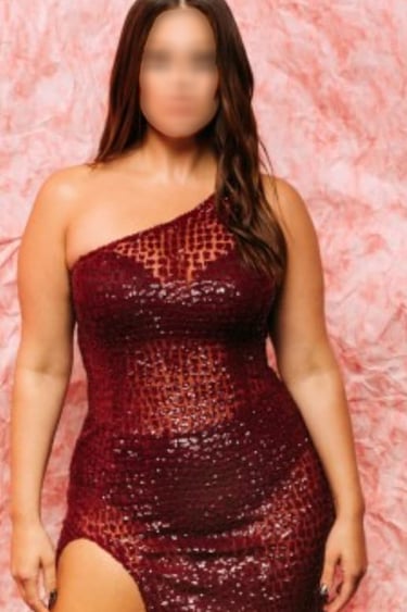 a woman in a red dress with a thigh high slit