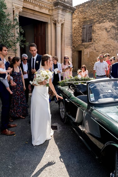 a bride and groomsmid are getting ready to get married