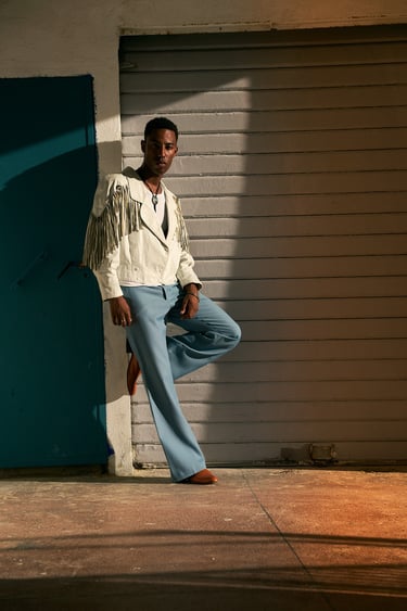 man in a stylish pose during a portrait session in Endoume, Marseille.