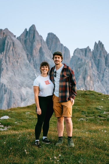 Laura and her partner Sam on a mountain in the Dolomites after filming an elopement on a mountain!