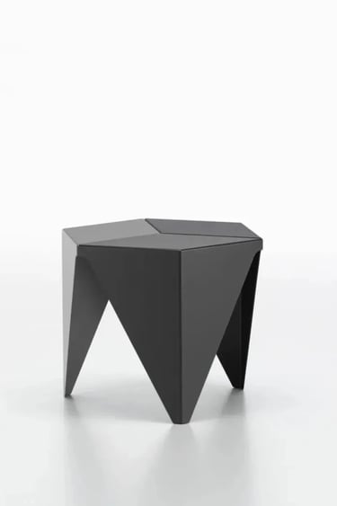Black sculptural stool with folded geometric form, reflecting Noguchi-inspired visual lightness in f