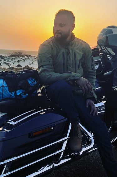 a man sitting on a motorcycle with a motorcycle
