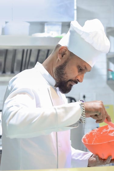 a chef in a white chef's hat and a chef's hat