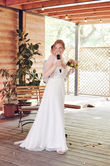 Bride holding a microphone.