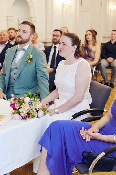 Bride sitting during a civil ceremony.
