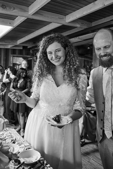 Bride and groom with a plate of cheese with grapes.