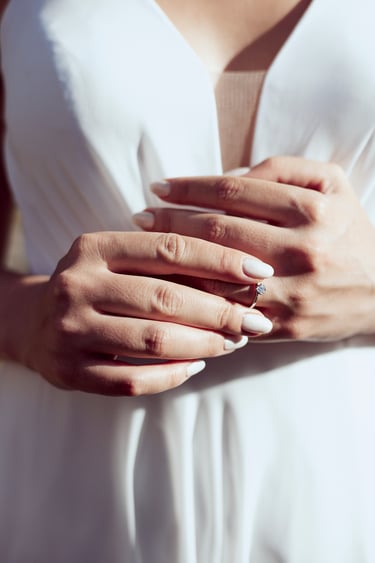 Bride touching her engagement ring.