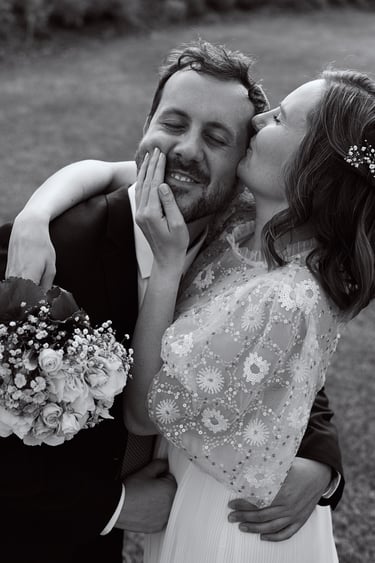 Bride kissing grooms temple.