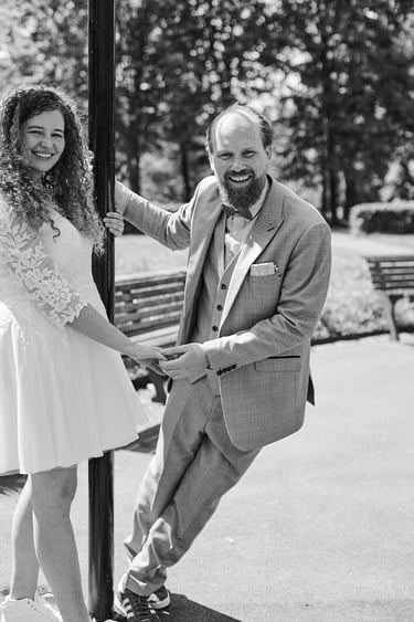 Groom holding onto a pole and bride's hand.