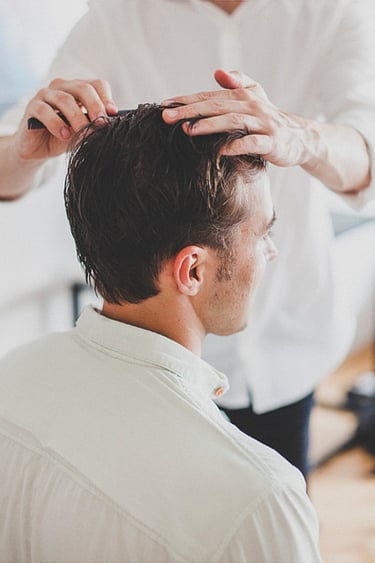Groom getting a haircut.