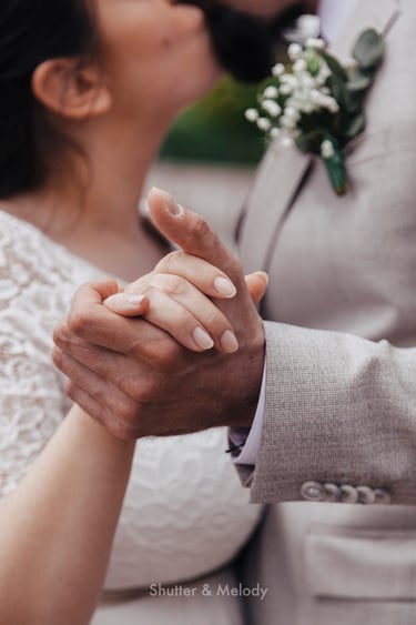 Close-up of bride's and groom's hands.