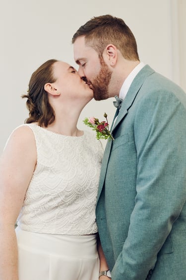 Bride and groom kissing after ring exchange. 