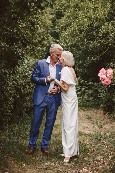 A mature couple in love standing in a garden.