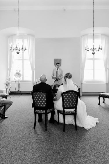 Wedding officiant speaking to the bride and groom.